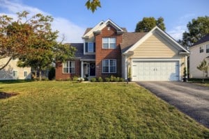 brown-house-with-trees-in-front-green-lawn