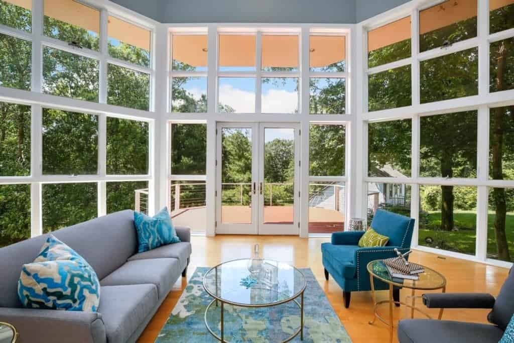 Living room surrounded by glass. Outdoor allergens not far from coming inside your home to create indoor allergies