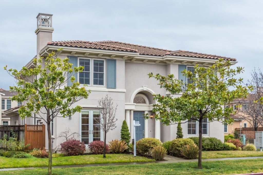 Two story home with blue shutters