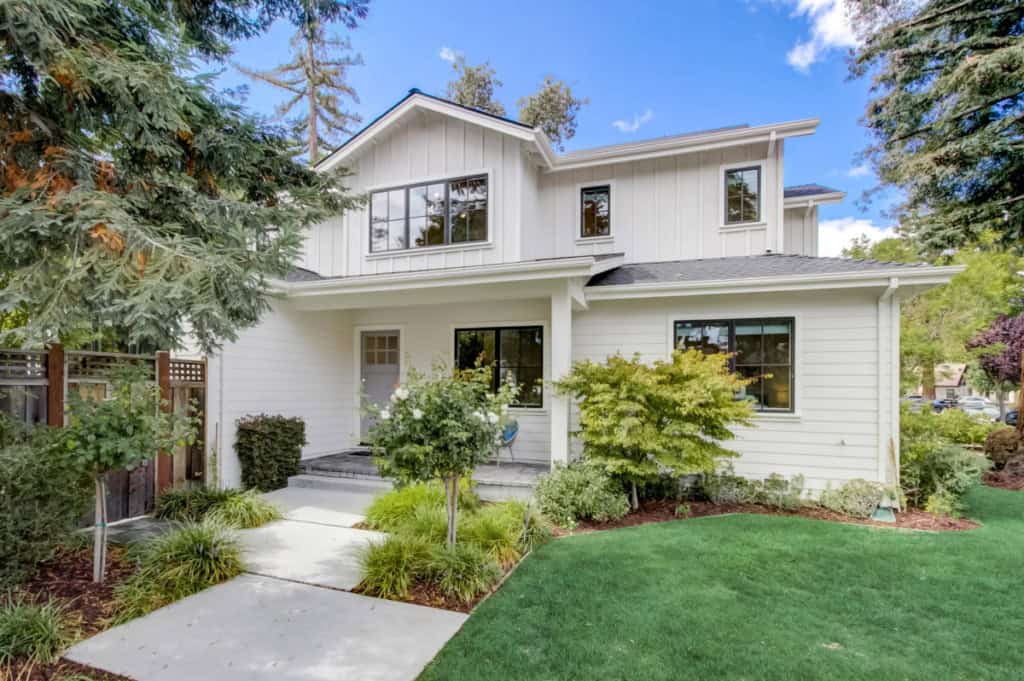White two-story home with landscaping