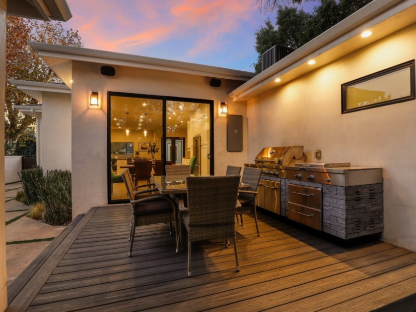 outdoor kitchen with gas grill island, warming drawers, and storage