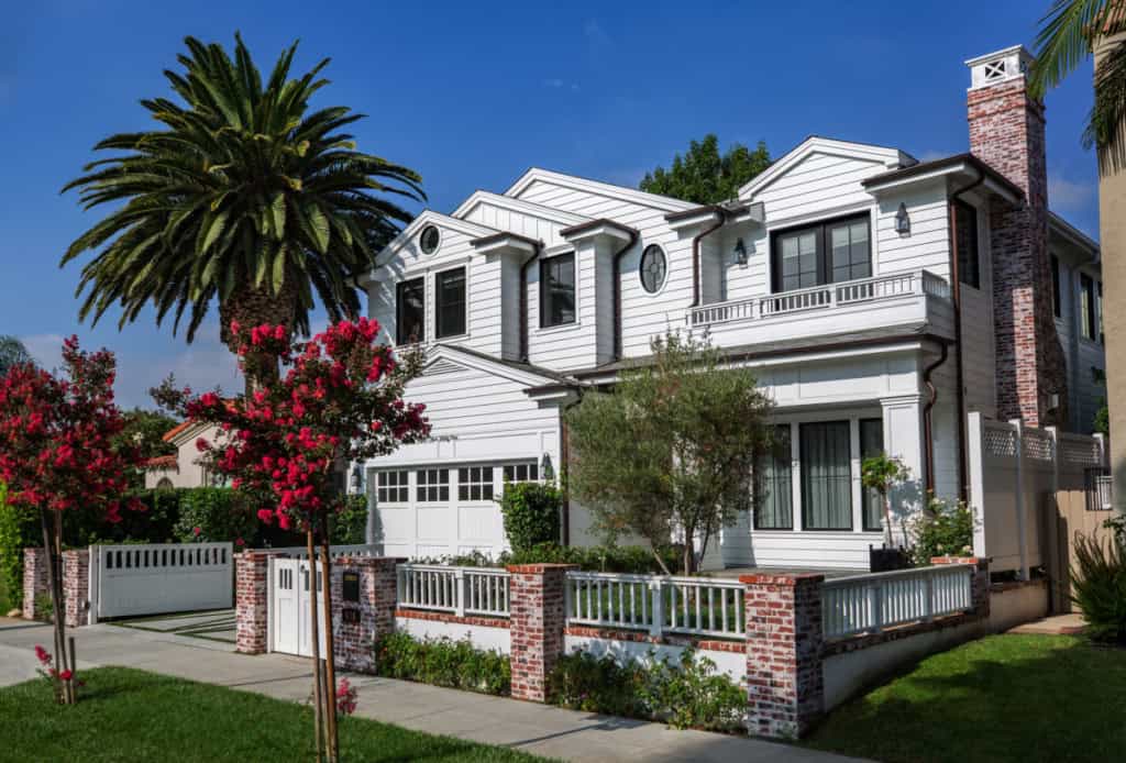 white house with palm trees and black trim