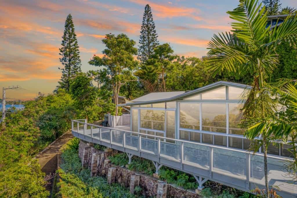 Grey house with lots of windows using solar tint