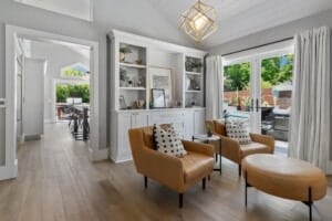formal living room with bookcases and leather chairs