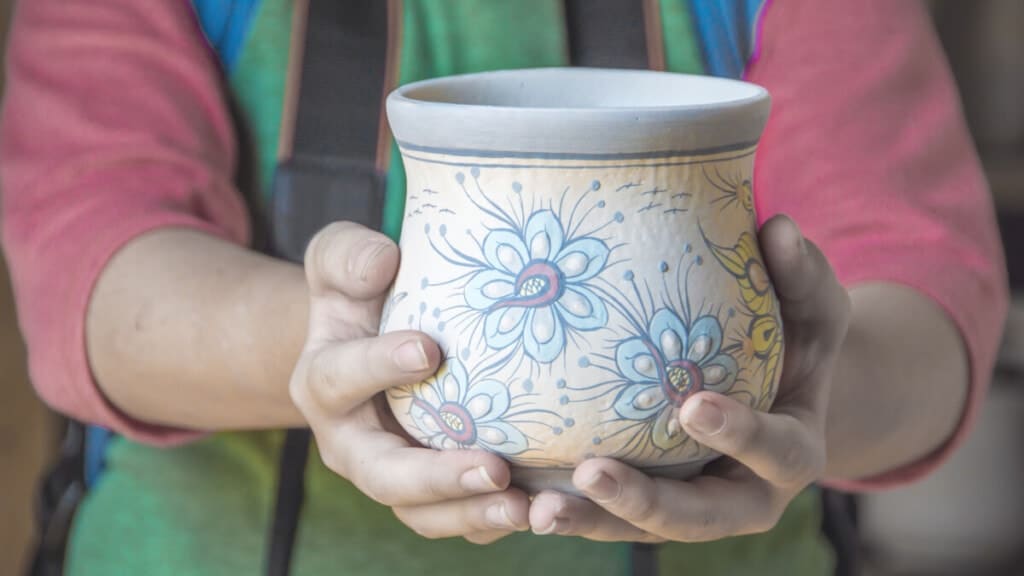 Boy holding mayan pottery on hands