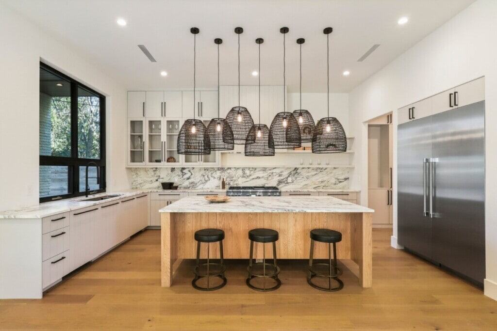 modern kitchen with island bar and statement lighting