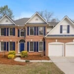 colonial home with garage and blue shutters