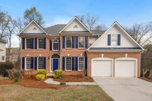 colonial home with garage and blue shutters