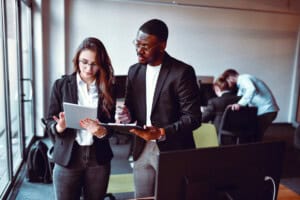 a man and a women employee assessing papers