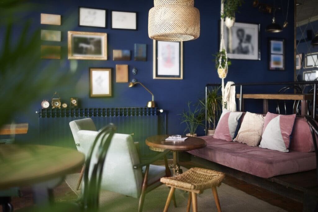 getty - maximalist living room with photograph wall an rattan pendent light