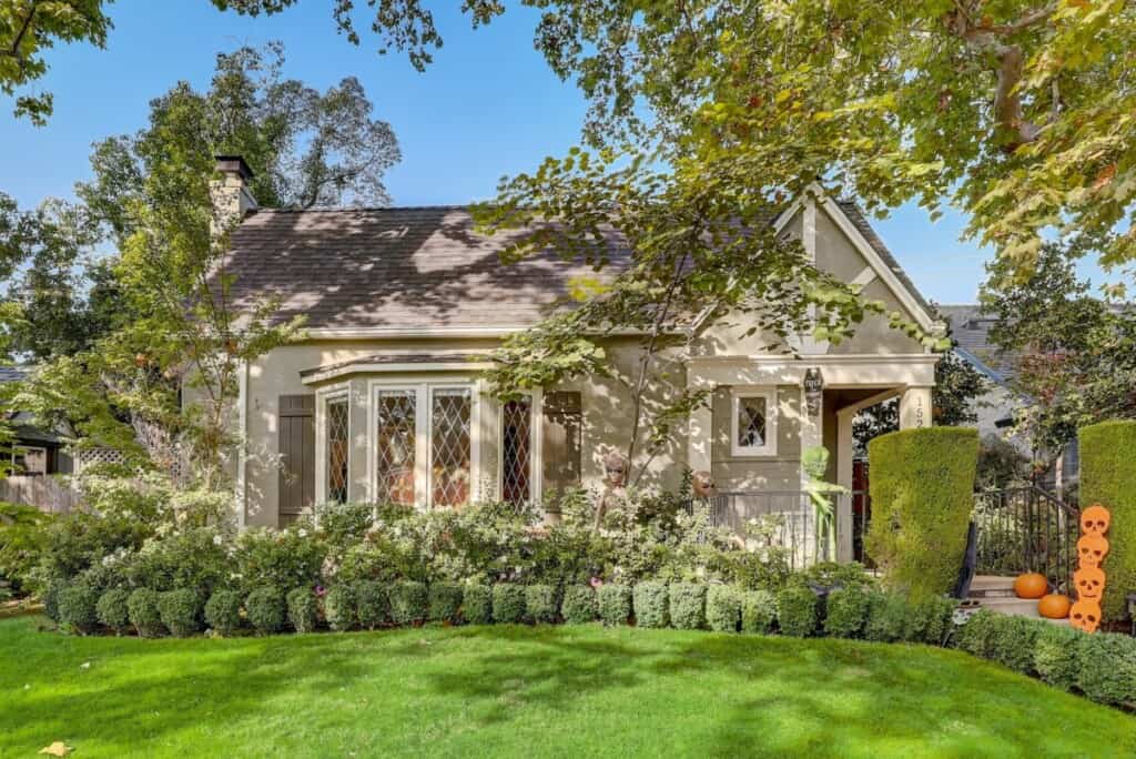house with lots of trees and green lawn