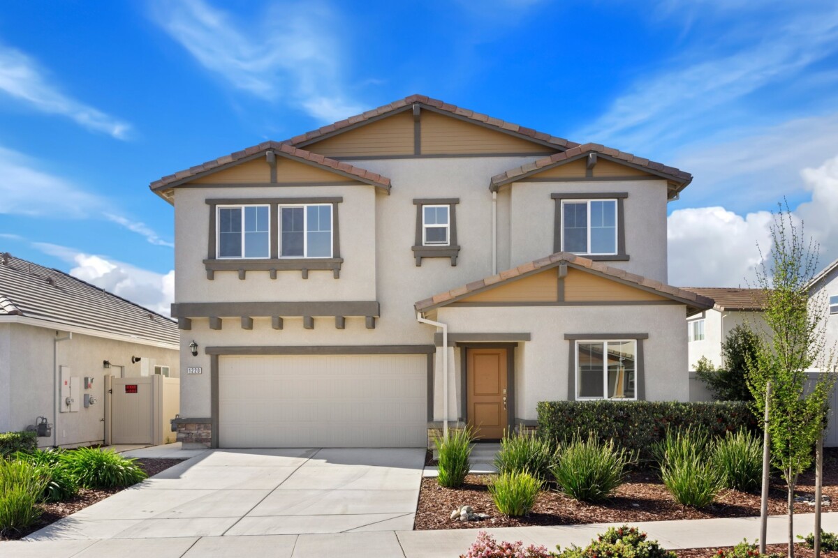 single family home with landscaped front yard and grey trim in south natomas neighborhood