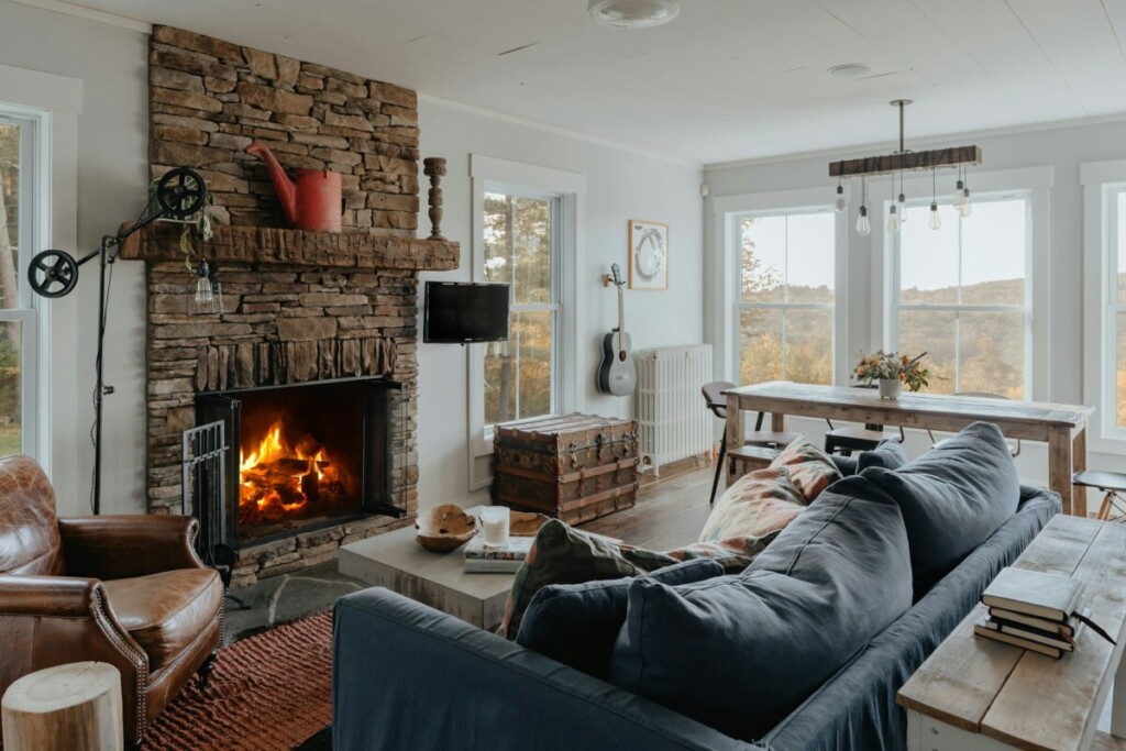 Cozy living room with a soft blue couch and a fireplace
