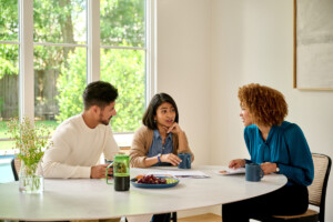 Couple discusses the process of selling a house with a mortgage with their real estate agent