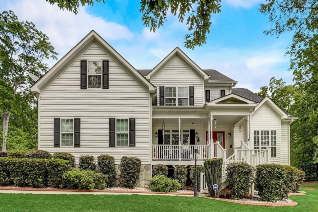 white home with red door black shutters and curb appeal