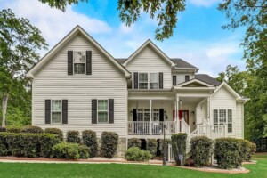 white home with red door black shutters and curb appeal