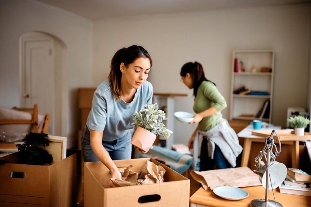 Two women packing up their home on short notice
