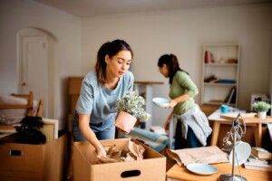 Two women packing up their home on short notice