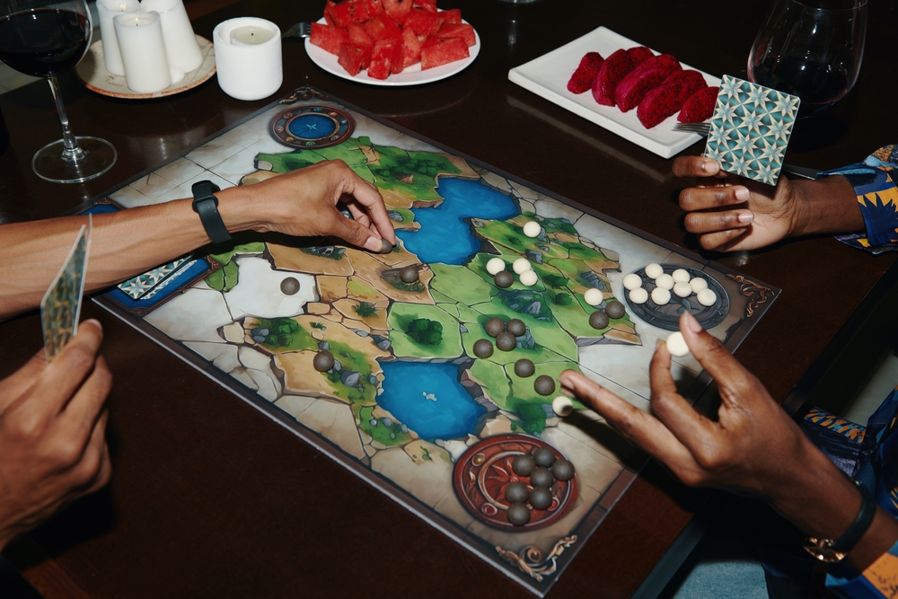 hands playing a board game