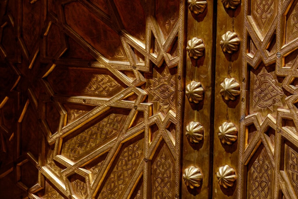 decorating with brass - up-close photo of ornate brass door