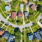 Downward view circle road in neighborhood with houses in summer aerial HOA