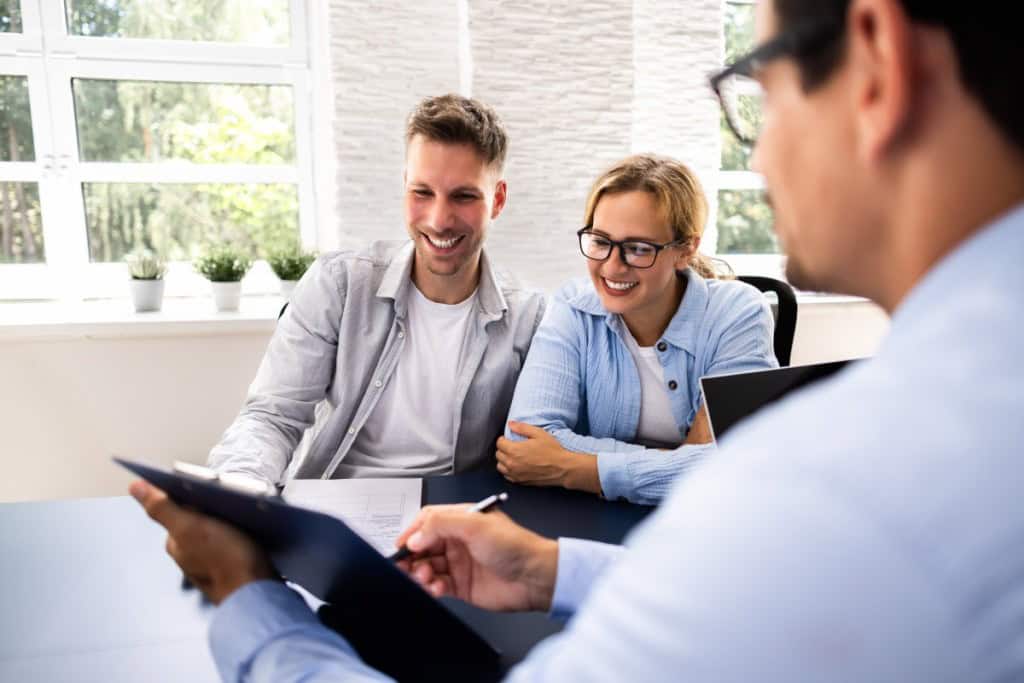 real estate agent discussing mortgage options with a family during a loan consultation