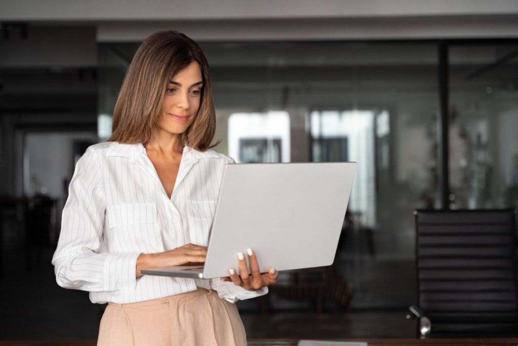Woman virtually signing the paperwork on her newly purchased home