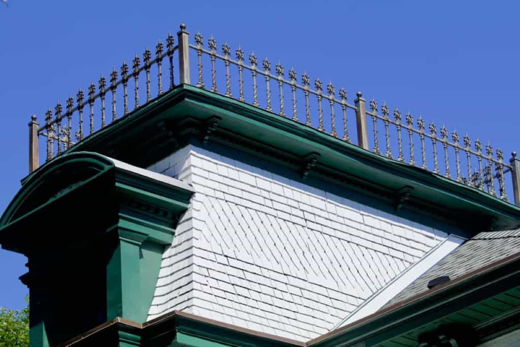 A wrought-iron widow's walk topping a 19th century house