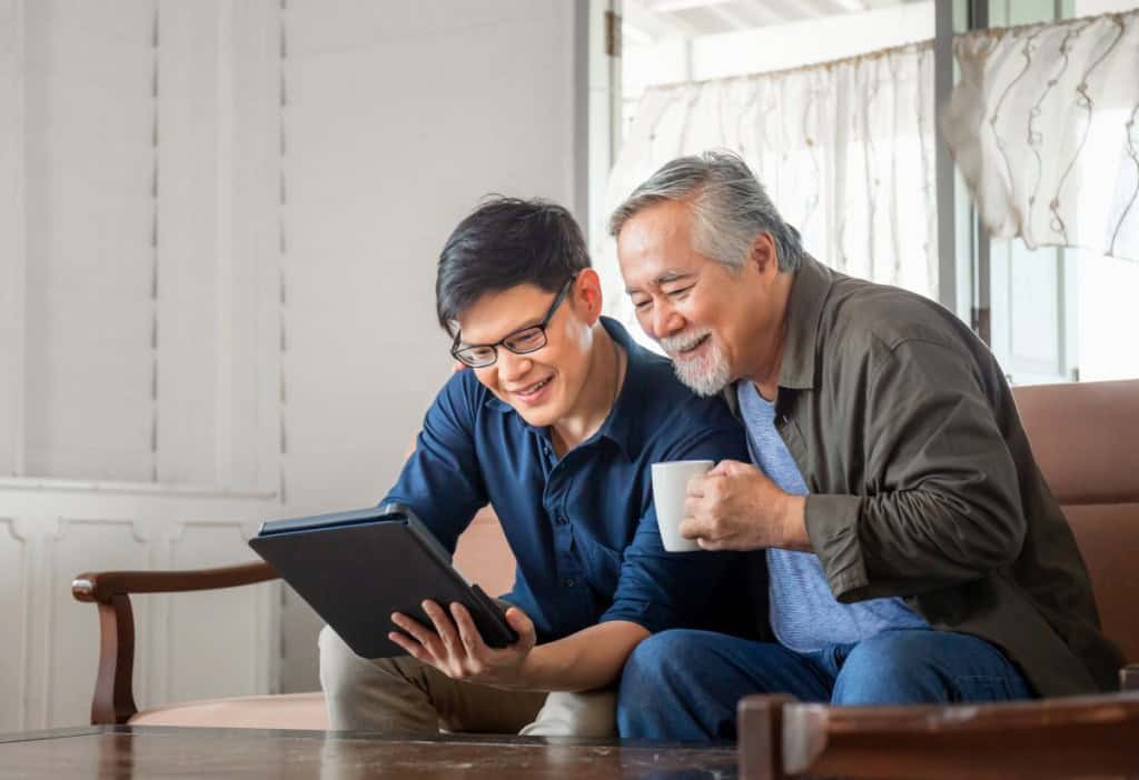 A father and son sit together and discuss buying a home from a family member.