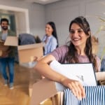 A young woman packing up boxes for a move across town
