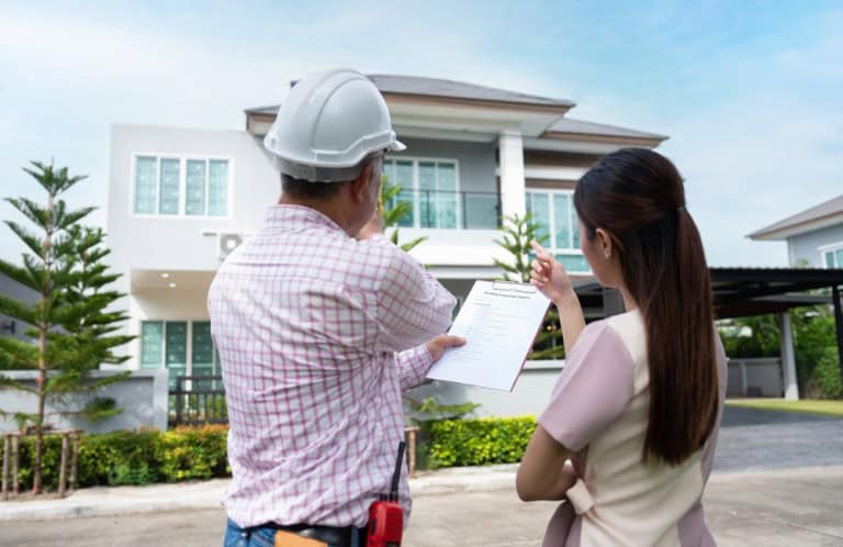 home inspector and potential buyer examining the home