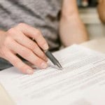 Person reviewing lease agreement when selling a tenanted rental property