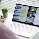 A person looking at an online home searching platform, shopping for homes on their computer