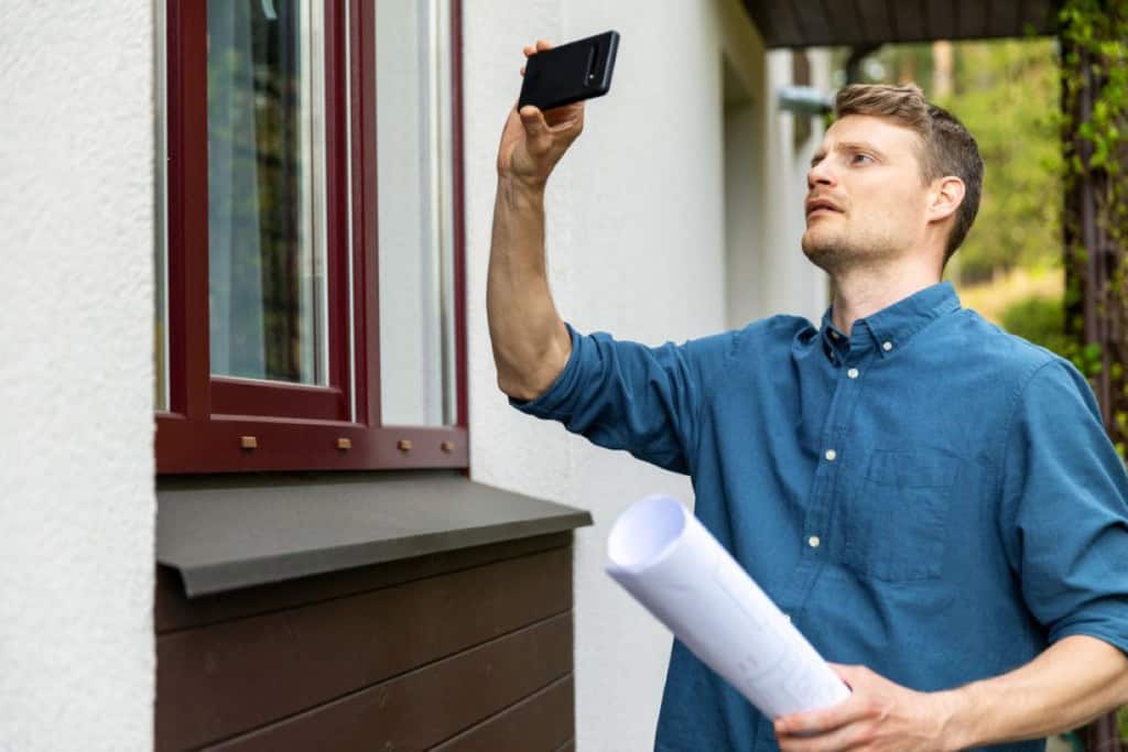 an appraiser quickly looking at the outside of a home during a drive-by appraisal
