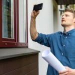 an appraiser quickly looking at the outside of a home during a drive-by appraisal