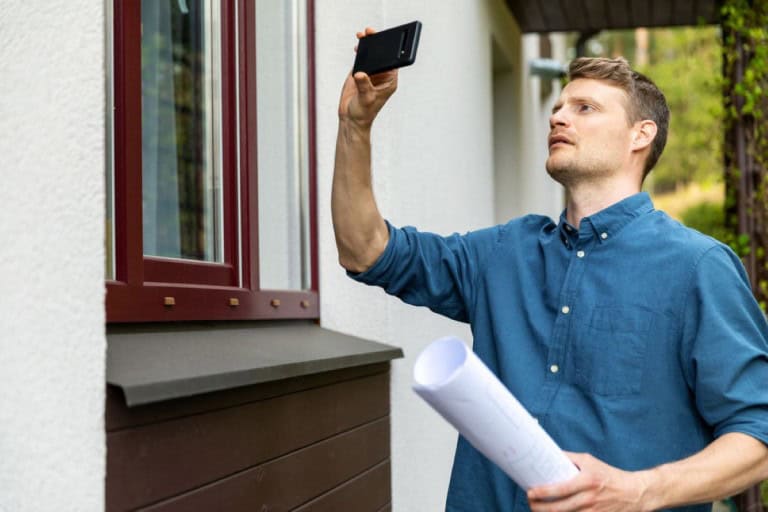 an appraiser quickly looking at the outside of a home during a drive-by appraisal