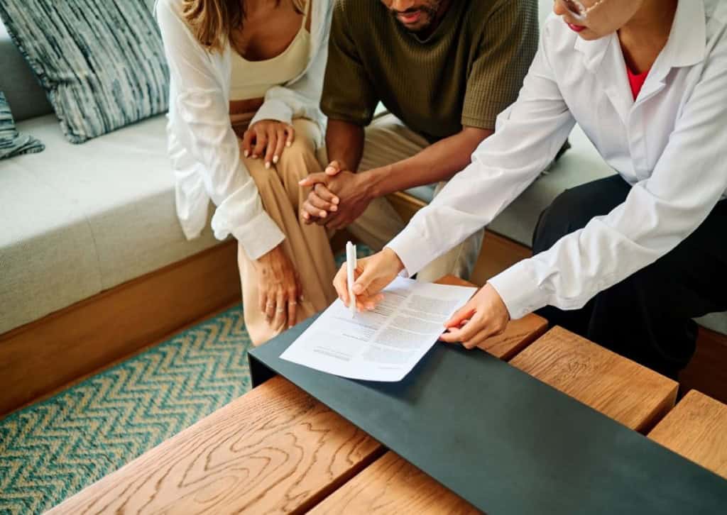 Home buyers looking over paperwork with their agent/