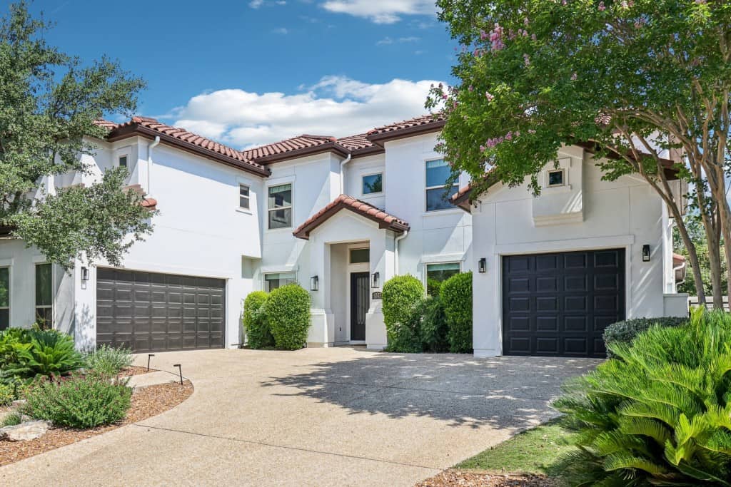 beautiful white home surrounded by lush trees