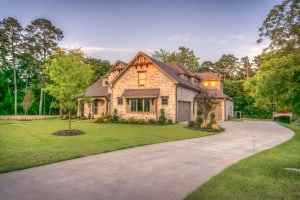 Stone suburban home with manicured lawn at sunset, highlighting days on market real estate.