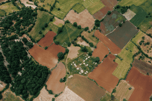 Illustration showing layers of land with surface property above and underground layers representing mineral rights ownership, such as oil, gas, and minerals beneath the surface