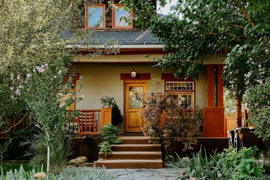 A bungalow home surrounded by mature landscaping, perfect for a first time homebuyer