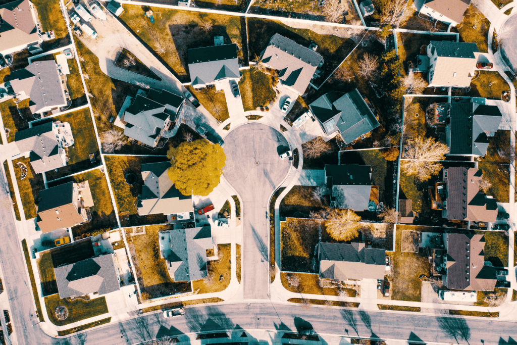 Aerial view of a Texas suburban neighborhood with homes around a cul-de-sac, commonly seen in planned developments when explaining what is mud in real estate.