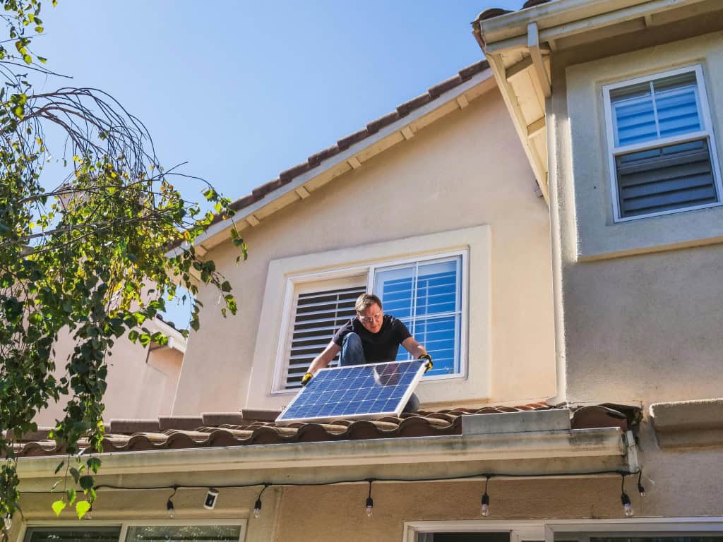 man installing solar panel