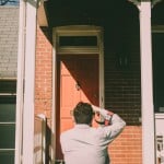 photographer taking an image of the front of a house