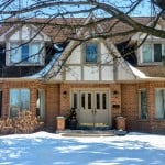 exterior of a house with a snow-y lawn