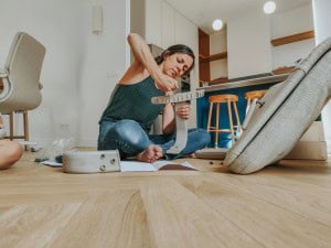 Lady on the floor fixing something