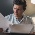 man looking at papers